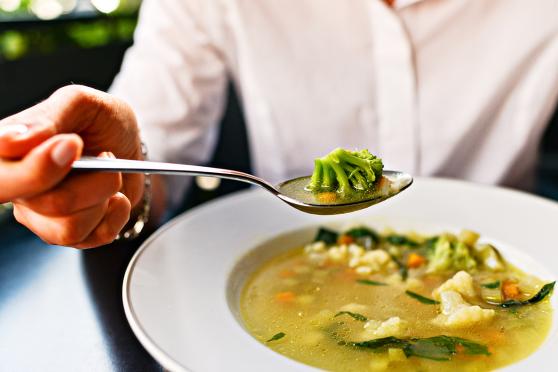 Woman eating soup