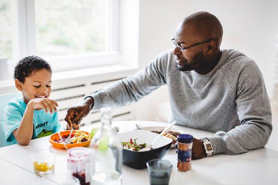 Father and son eating a meal